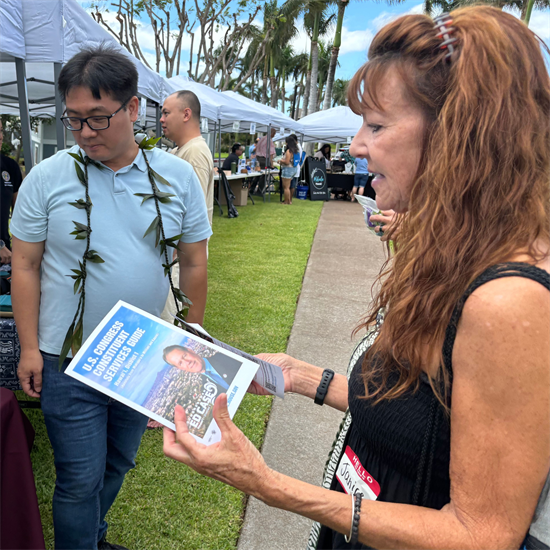 Constituent at Fairway Village Community Fair with Congressman Case Constituent Services Guide